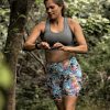 Photo of women running with her all terrain running shoes in the bush.